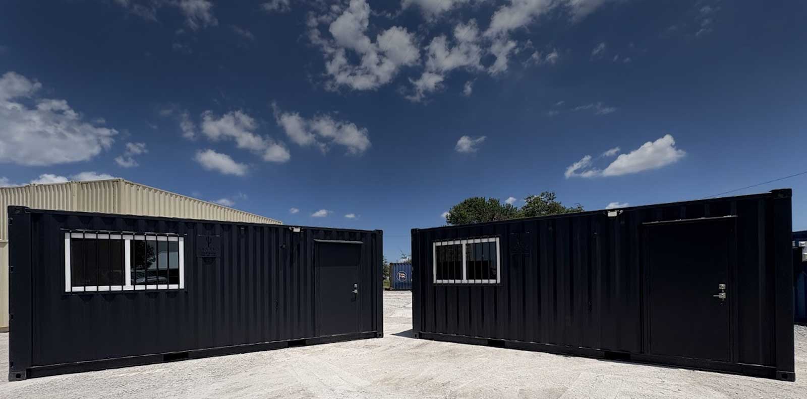 Stacked 40-foot shipping containers at a Cactus Containers yard in Texas